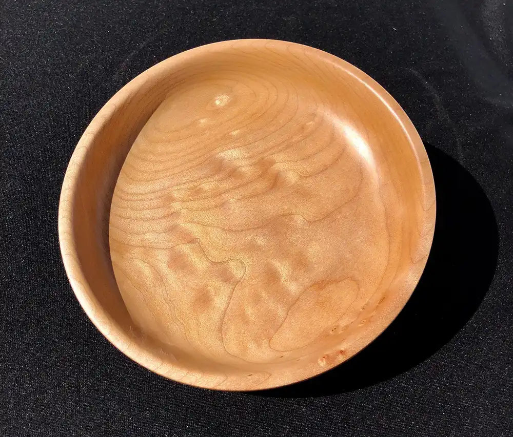 Wooden bowl on a black background