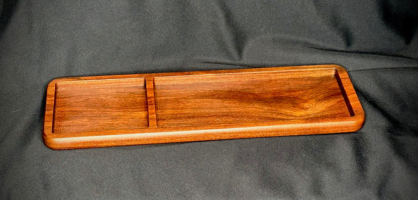 Wooden tray with compartments on a gray fabric background