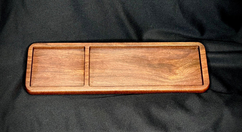 Wooden tray with two compartments on a black fabric background