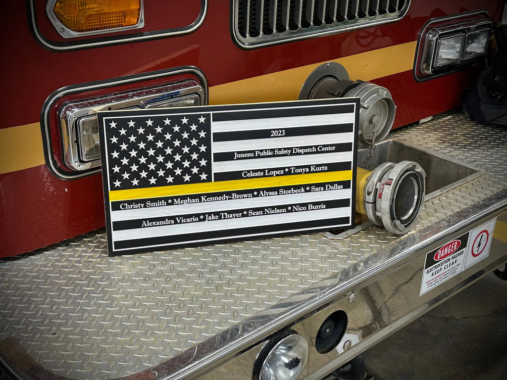 A plaque featuring an American flag and names on the front.
