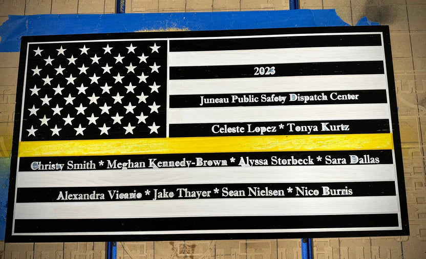 A plaque featuring an American flag and names on the front.