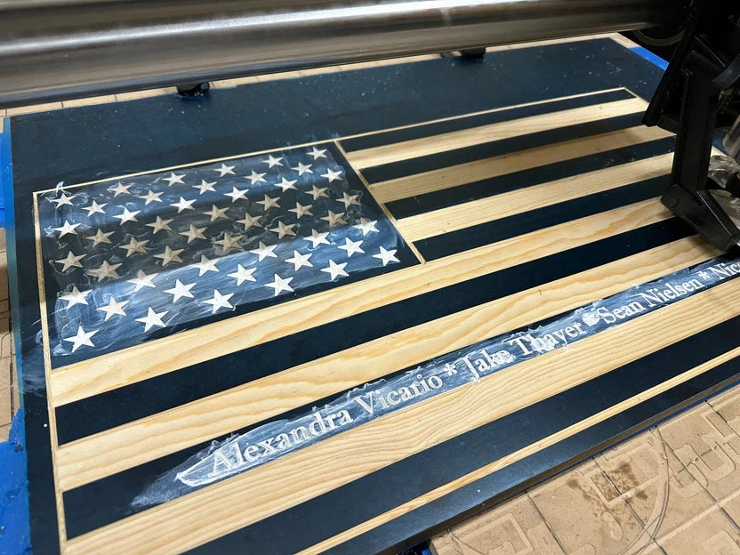 Wooden American flag with engraved names on a blue background