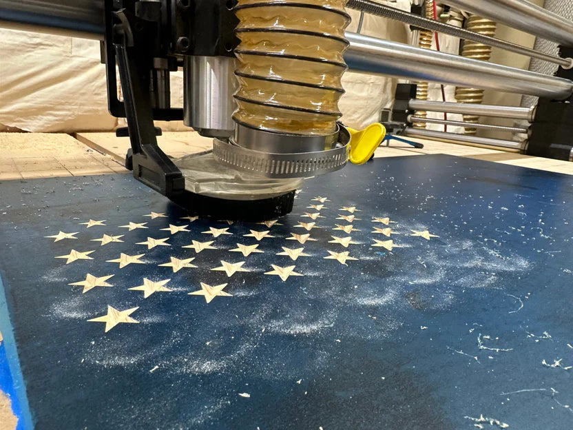 CNC machine cutting a star pattern on a blue material