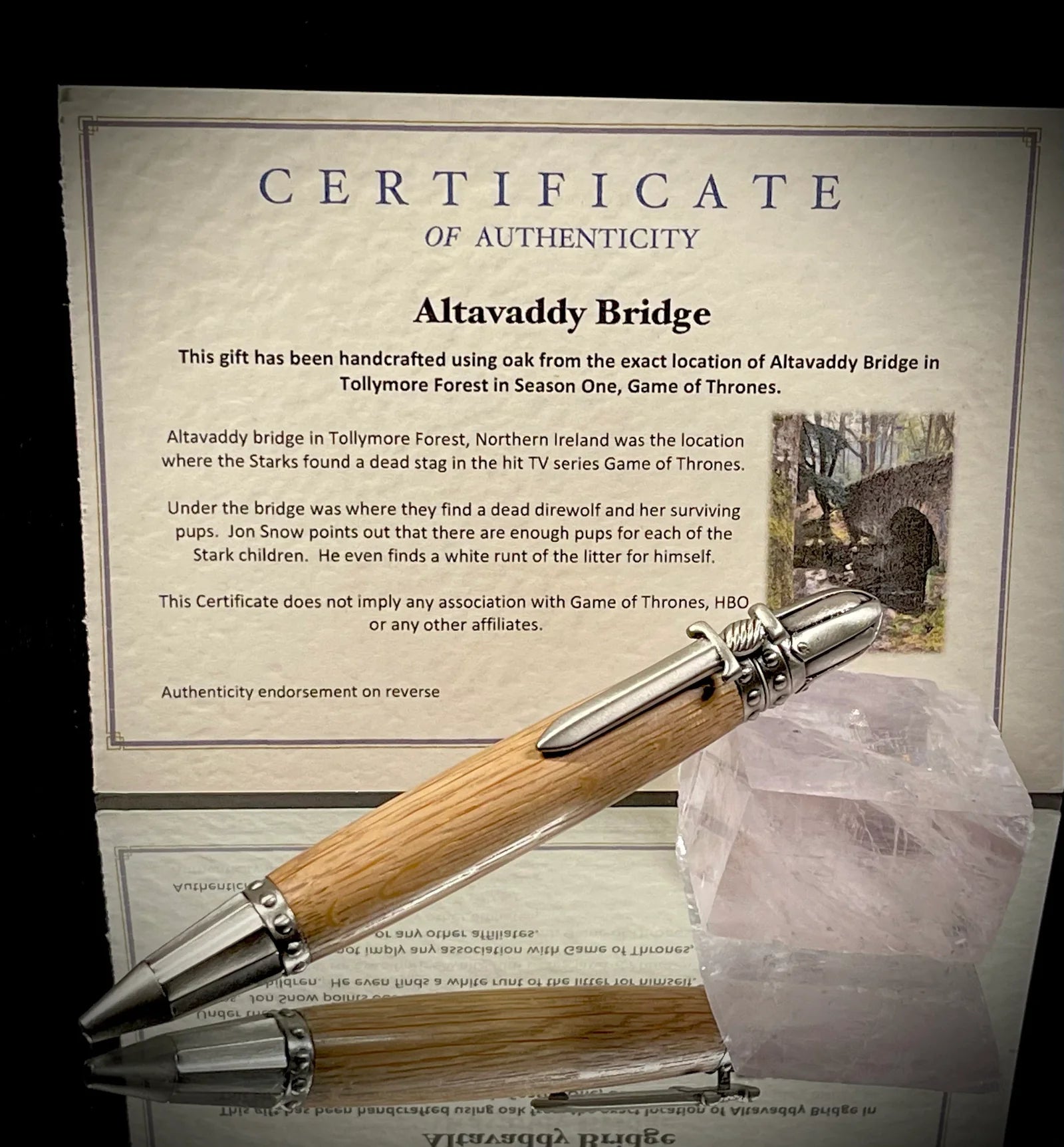 Wooden pen with silver accents on a certificate of authenticity for Altavaddy Bridge, Game of Thrones.