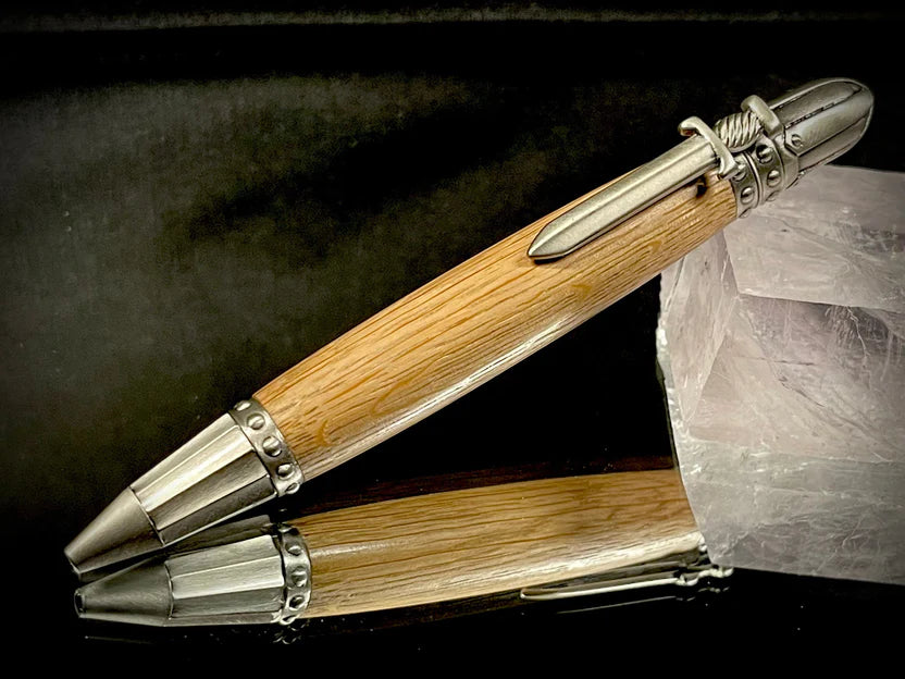 Wooden pen with silver accents on a dark surface
