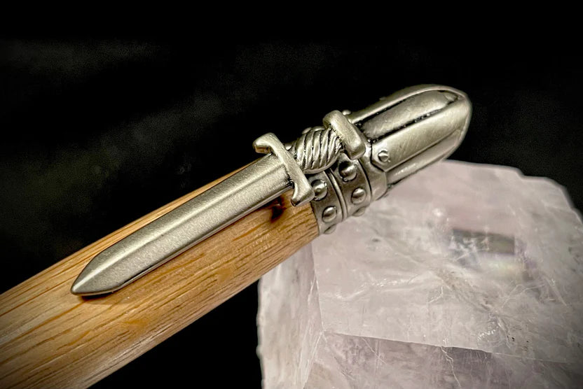 Wooden pen with metal accents on a textured surface