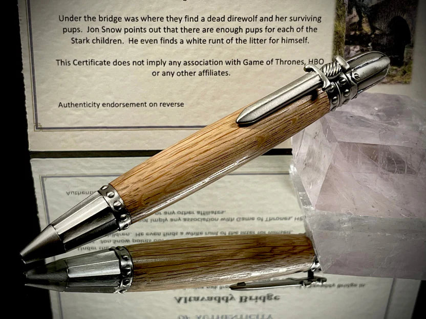 Wooden pen with metal accents on a textured surface