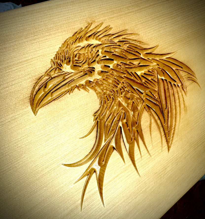 A raven's head engraved on tabletop weaving loom.